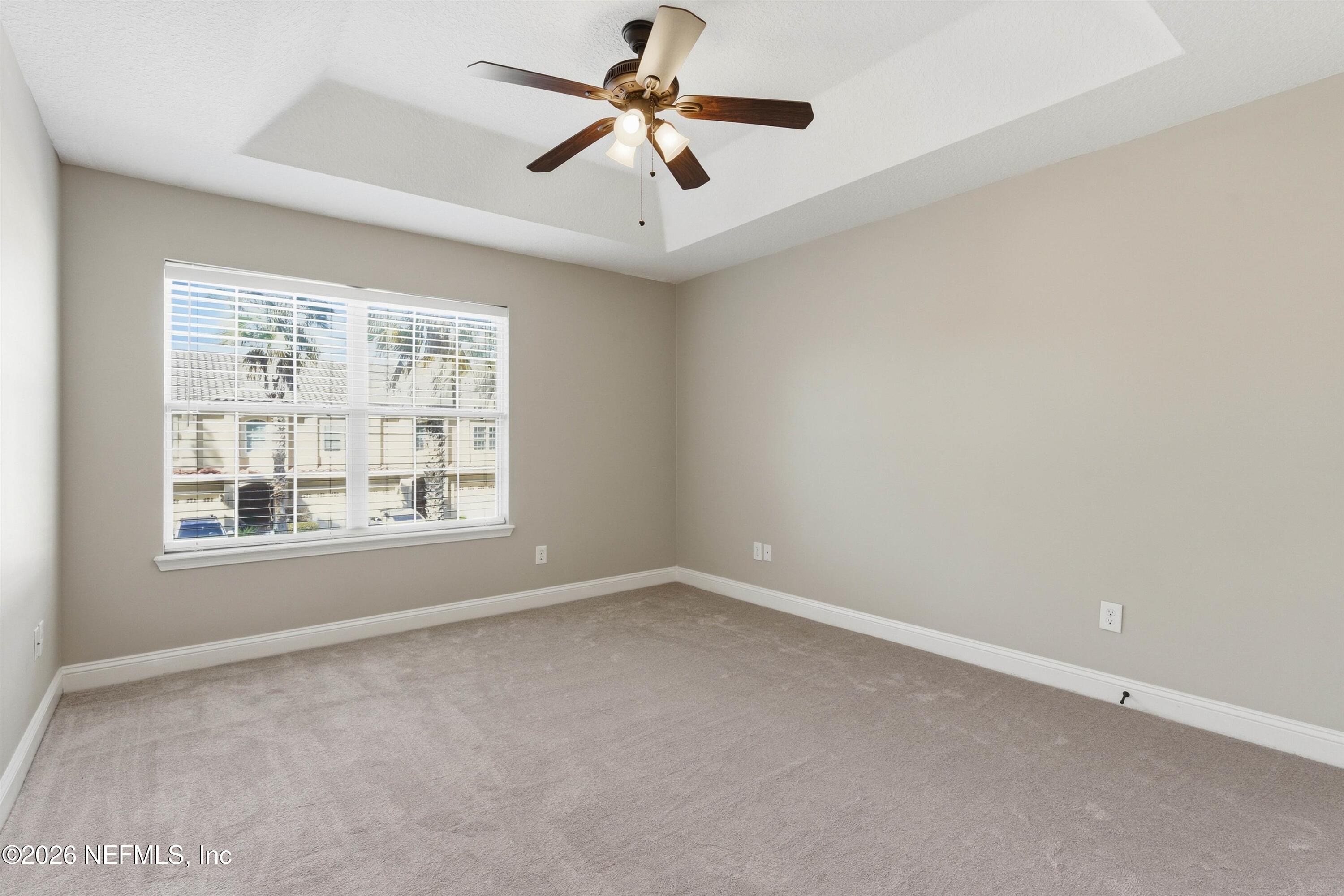 1733 Sanctuary Way Fleming Island, FL 32003 - Photo 26 of 39 an empty room with a window and a ceiling fan