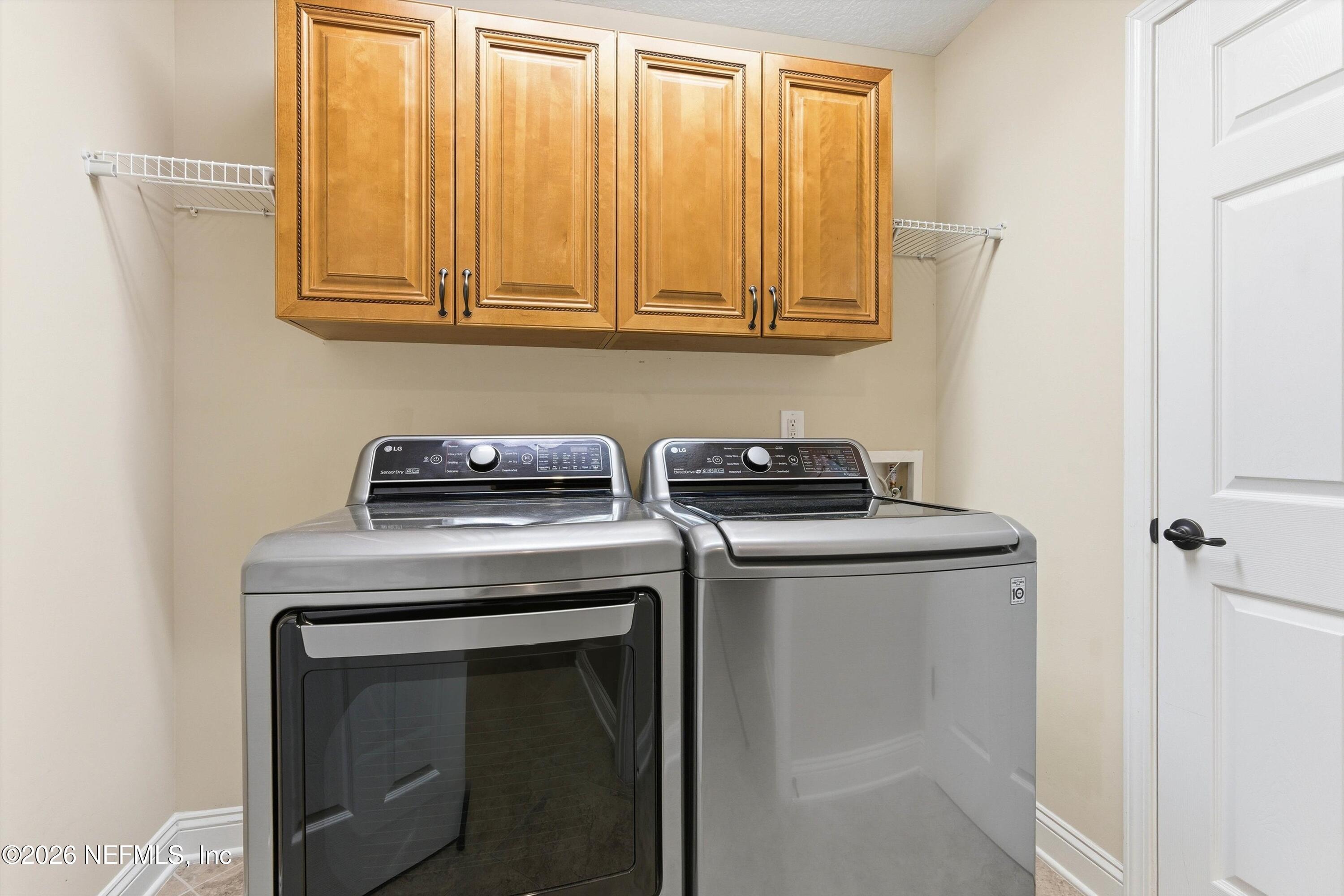 1733 Sanctuary Way Fleming Island, FL 32003 - Photo 31 of 39 a view of a utility room with washer and dryer