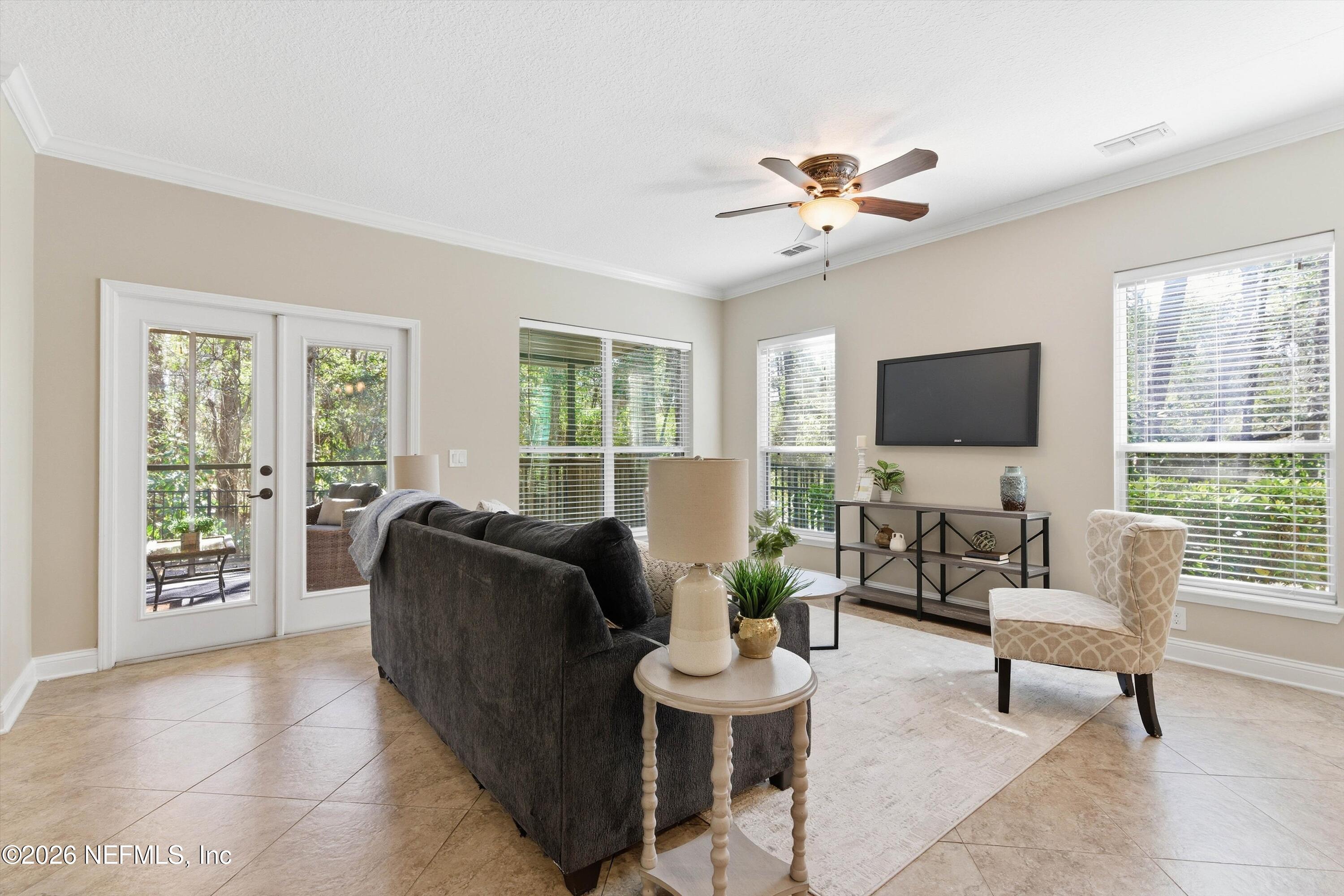 1733 Sanctuary Way Fleming Island, FL 32003 - Photo 8 of 39 a living room with furniture and a flat screen tv