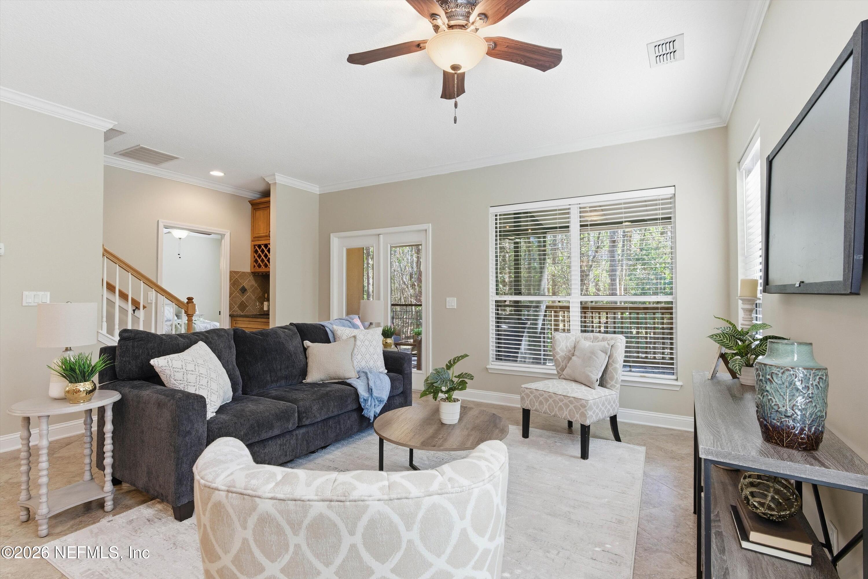 1733 Sanctuary Way Fleming Island, FL 32003 - Photo 9 of 39 a living room with furniture and a large window