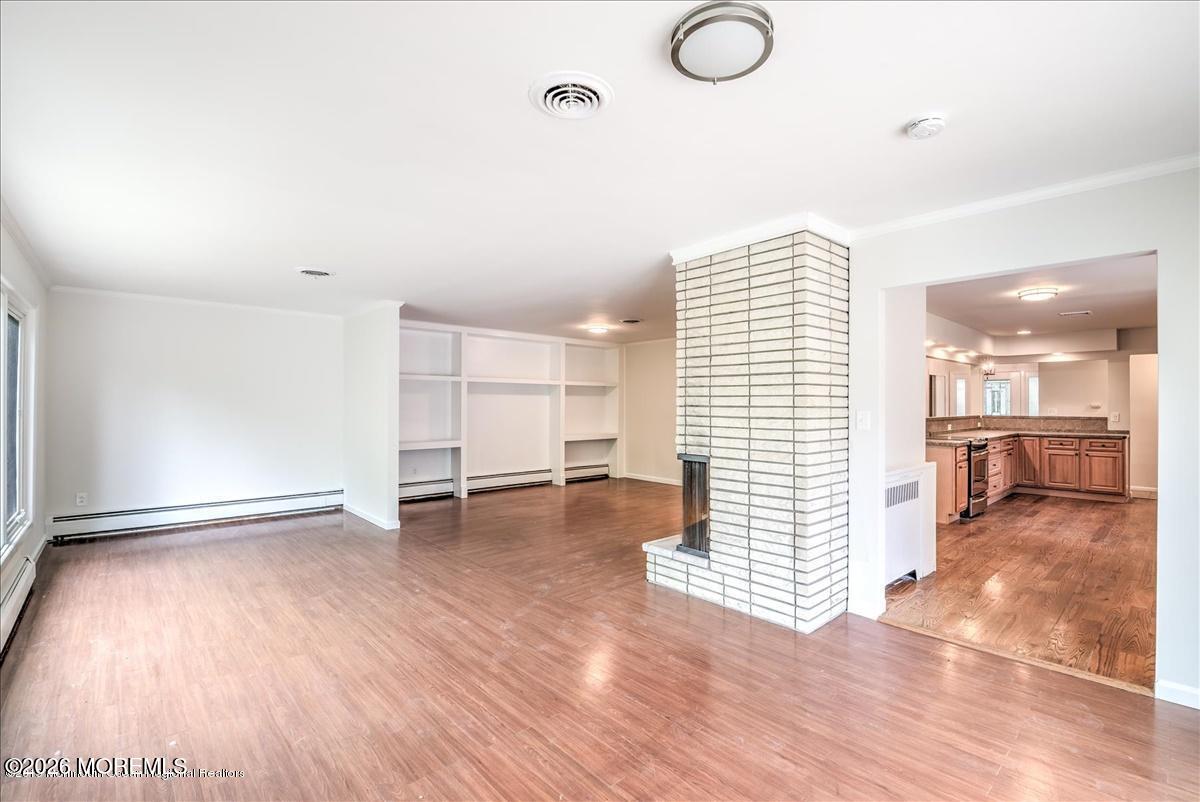 699 Aldrich Road Howell, NJ 07731 - Photo 8 of 23 a view of empty room with wooden floor and fan
