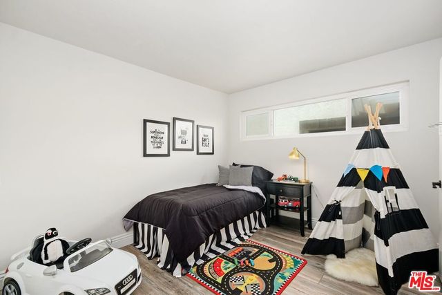 a bedroom with furniture and a wooden floor