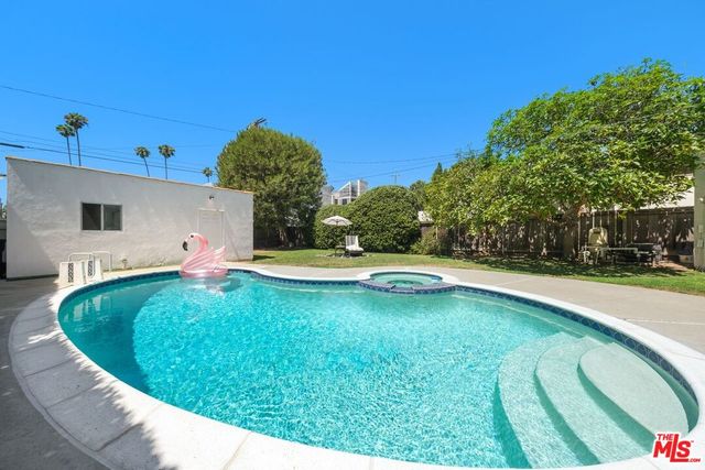 a view of a swimming pool with a yard