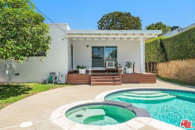 a view of a house with backyard porch and furniture