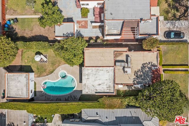 an aerial view of a house with a swimming pool