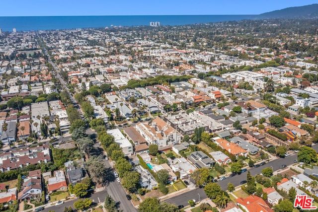 an aerial view of a residential houses with city view