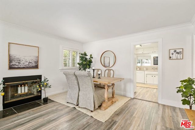 a view of a work space with furniture wooden floor and windows