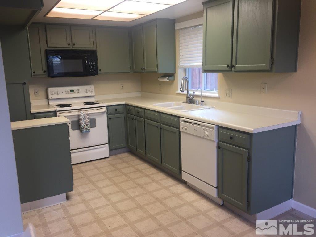 1336 Canyon Creek Road Reno, NV 89523 - Photo 2 of 32 a kitchen with stainless steel appliances granite countertop a sink stove and microwave