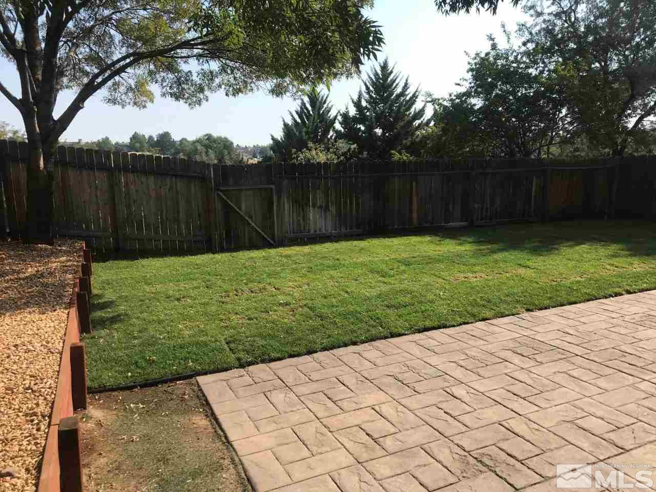 1336 Canyon Creek Road Reno, NV 89523 - Photo 28 of 32 a view of a backyard with wooden fence