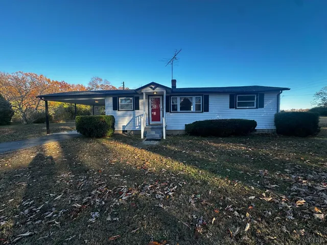 a front view of a house with a yard and a garage