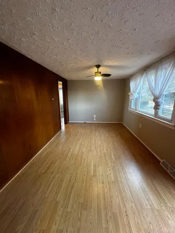wooden floor in an empty room with a window