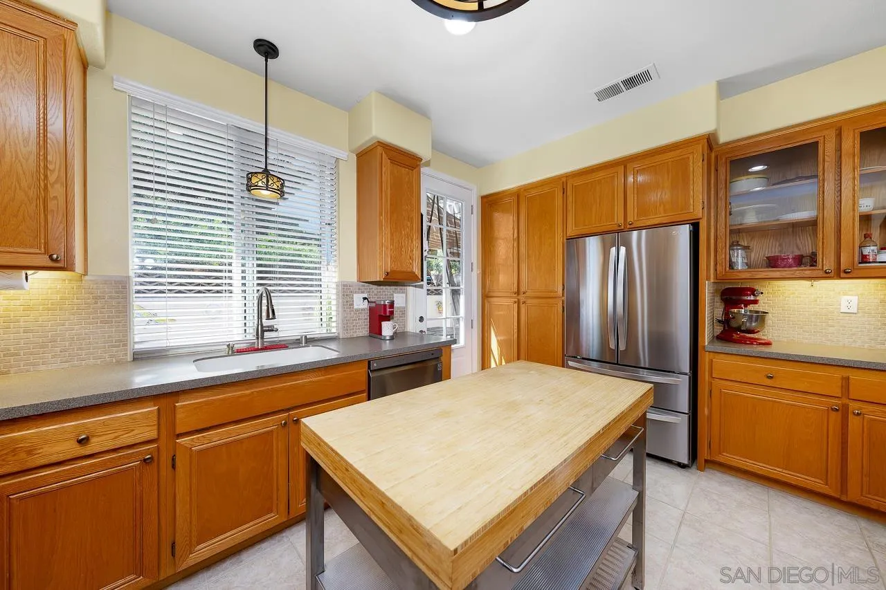 2460 Eagle Valley Drive Chula Vista, CA 91914 - Photo 12 of 35 a kitchen with stainless steel appliances granite countertop a refrigerator a sink dishwasher a stove and white countertops with wooden floor