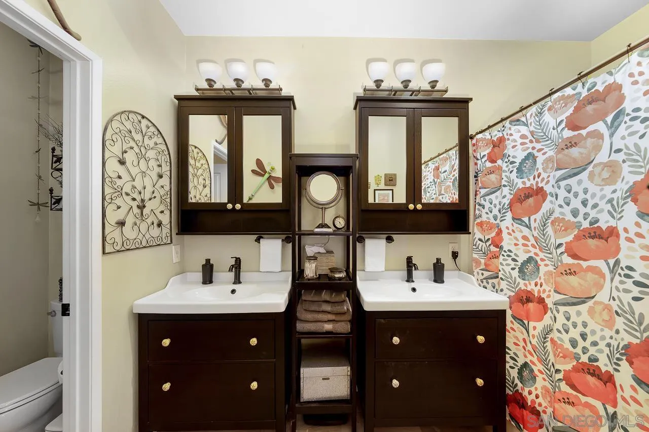 2460 Eagle Valley Drive Chula Vista, CA 91914 - Photo 20 of 35 a bathroom with a double vanity sink mirror and window