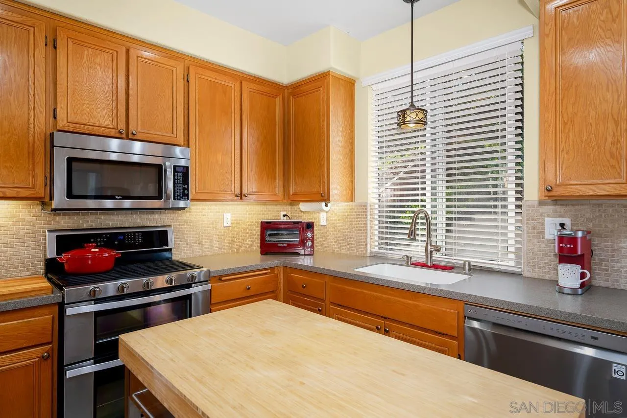 2460 Eagle Valley Drive Chula Vista, CA 91914 - Photo 10 of 35 a kitchen with a stove a sink and a microwave