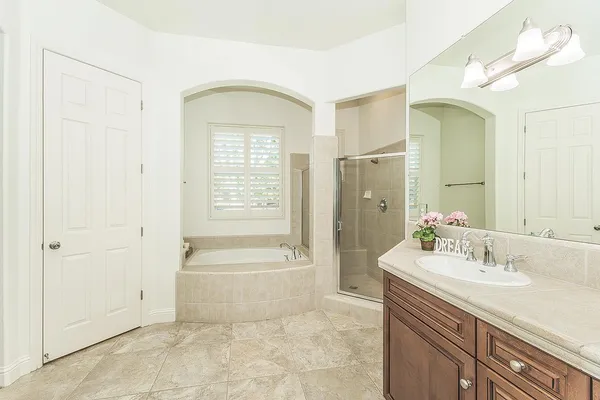a view of a white house with a yard and potted plants