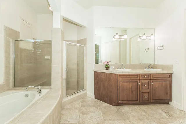 a large white kitchen with a sink cabinets and a window