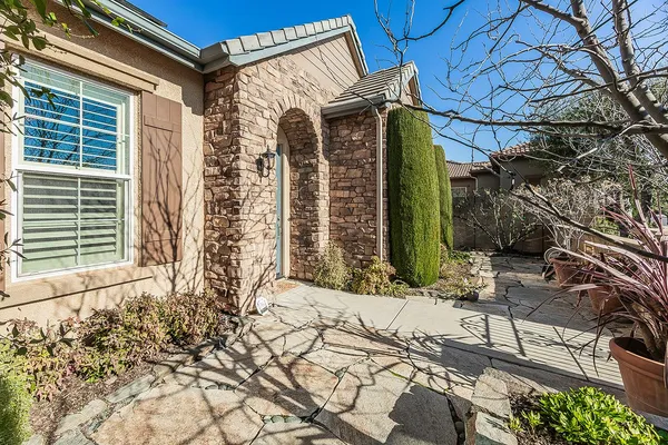 a living room with furniture a fireplace and a window