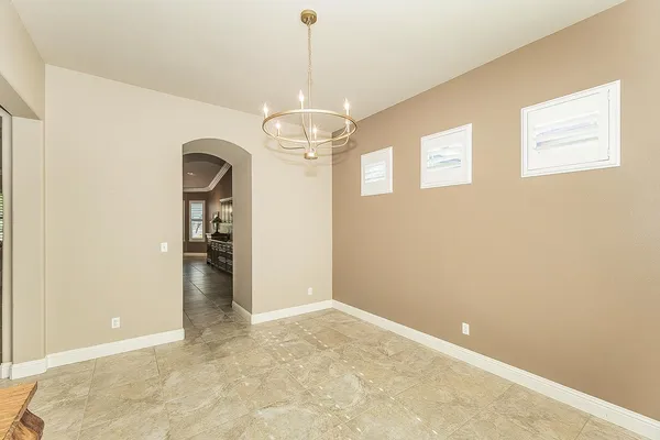 an empty room with a ceiling fan and a window