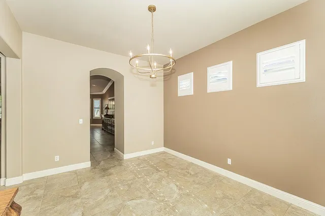 a living room with lots of furniture and view of kitchen