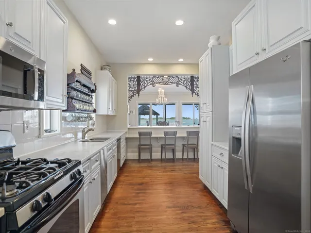 a kitchen with stainless steel appliances a refrigerator and a stove top oven