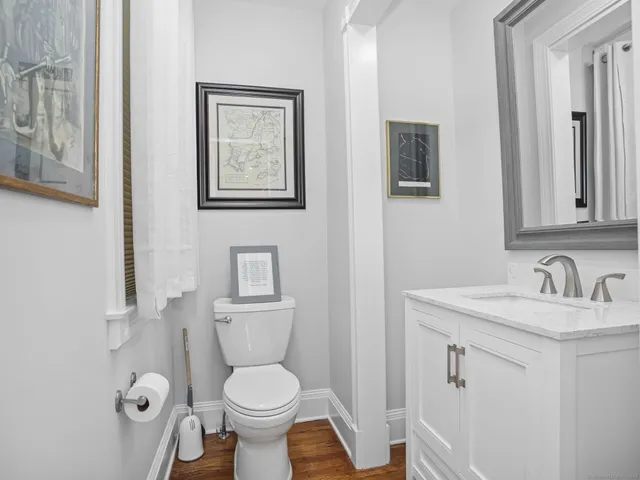 a bathroom with a toilet sink and mirror