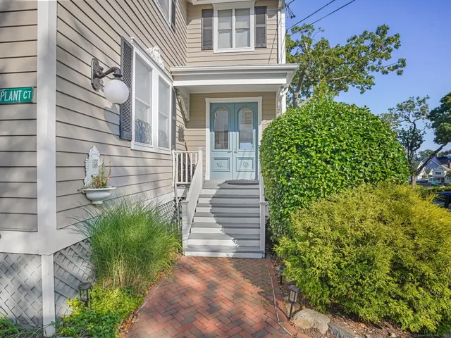 a view of a house with potted plants