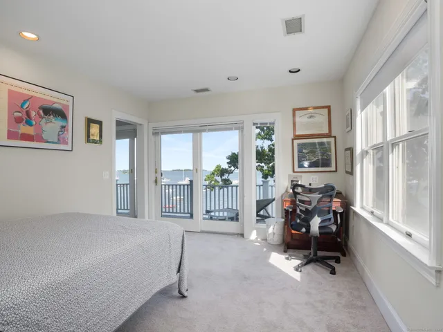 a bed room with a bed and a chair