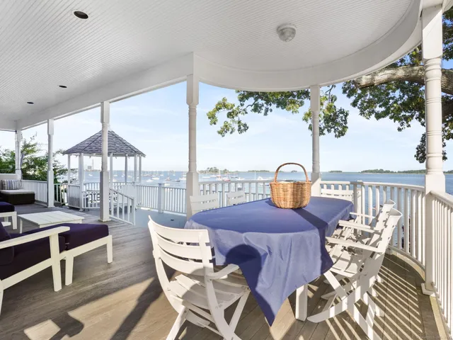 a view of a balcony dining table and chairs