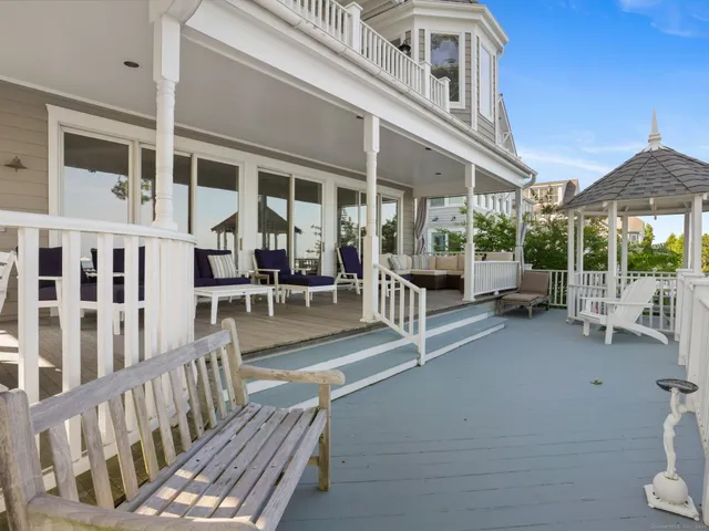 a view of a patio with a table and chairs and potted plants