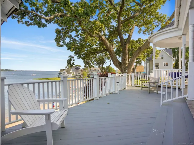 a view of a chair and tables in the balcony