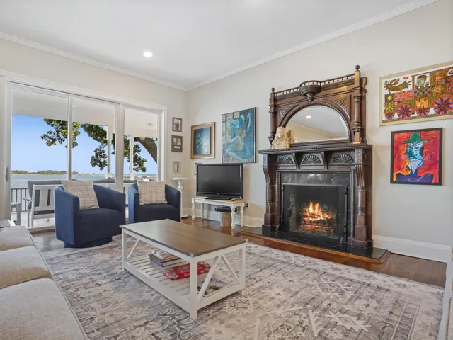 a living room with furniture a flat screen tv and a fireplace