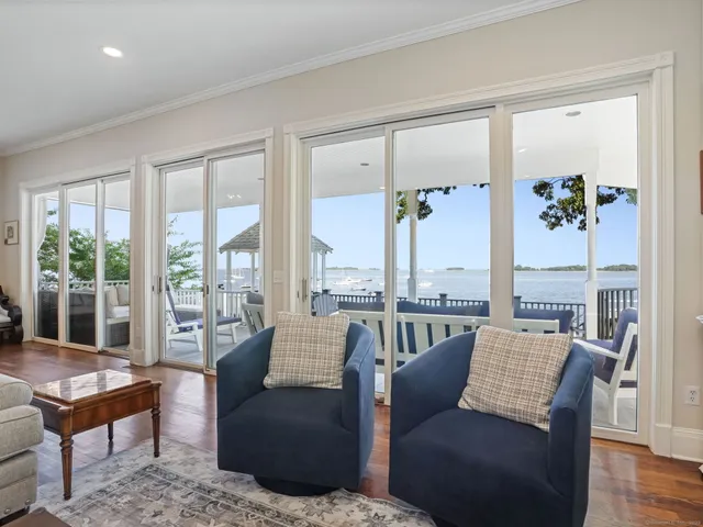 a living room with furniture and floor to ceiling windows