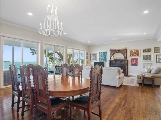 a view of a dining room with furniture wooden floor and chandelier