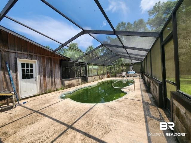 32749 Antietam Road Lillian, AL 36549 - Photo 37 of 47 View of pool with a lanai and a patio