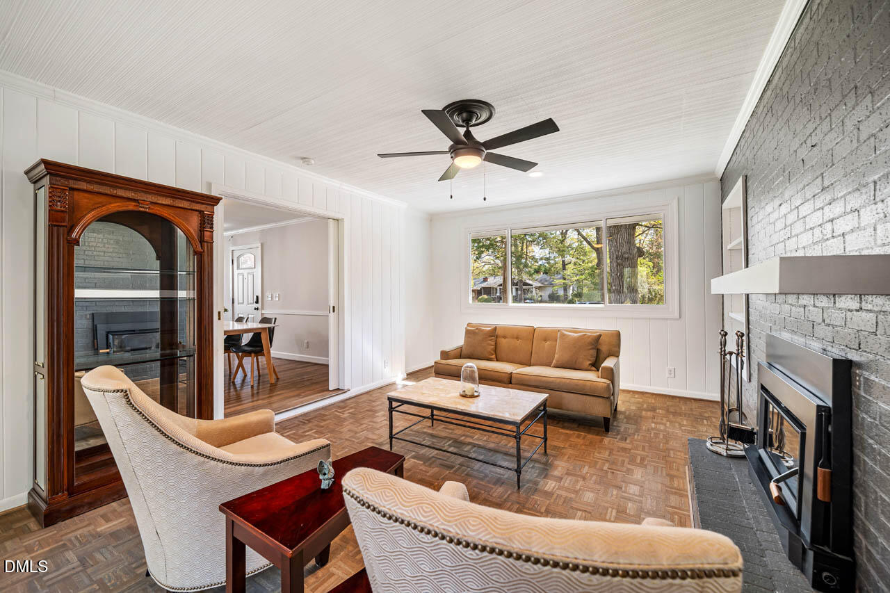 231 Flemington Road Chapel Hill, NC 27517 - Photo 14 of 48 a living room with furniture a fireplace and a large window