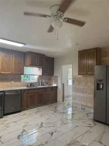 a large kitchen with cabinets and stainless steel appliances