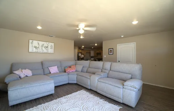 a living room with furniture and a ceiling fan