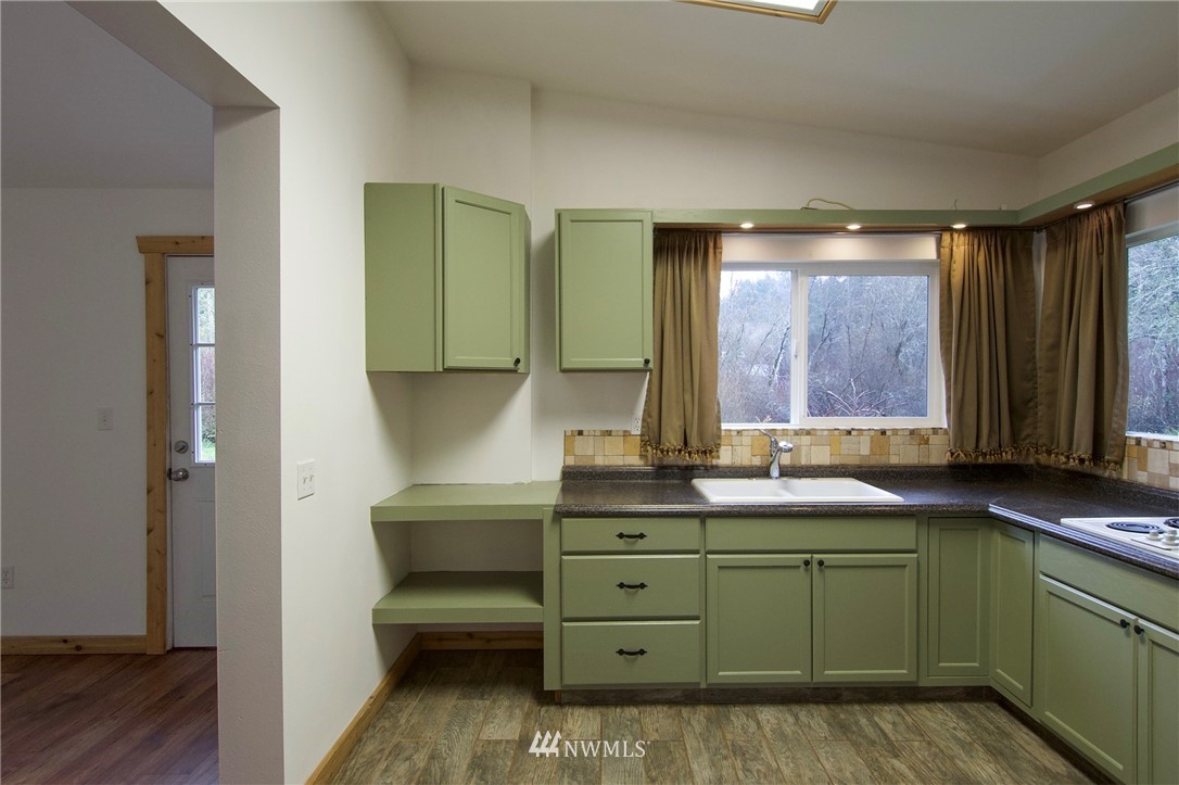463 Autumn Road Sequim, WA 98382 - Photo 12 of 40 a kitchen with a sink and a mirror