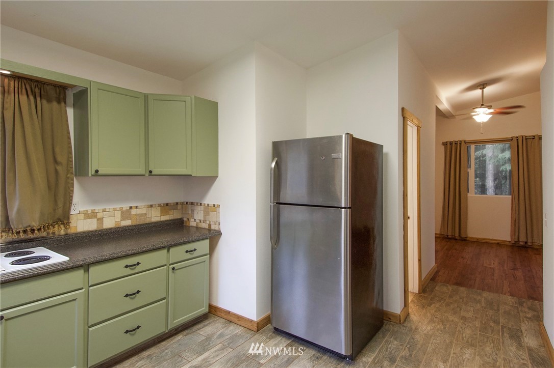 463 Autumn Road Sequim, WA 98382 - Photo 13 of 40 a kitchen with stainless steel appliances granite countertop a refrigerator and a stove