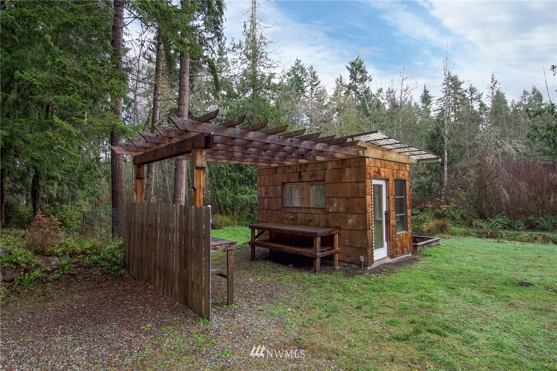 463 Autumn Road Sequim, WA 98382 - Photo 27 of 40 a view of a backyard with wooden fence and a bench