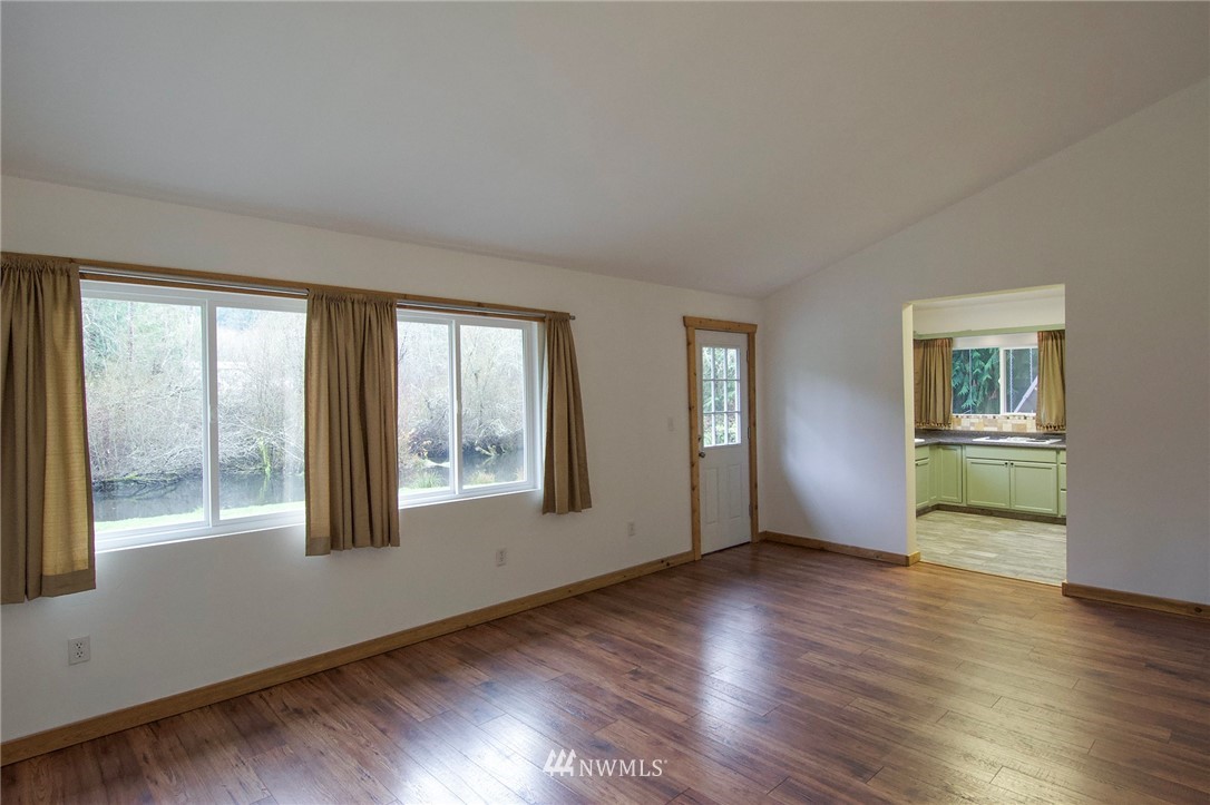 463 Autumn Road Sequim, WA 98382 - Photo 6 of 40 a view of an empty room with window and wooden floor