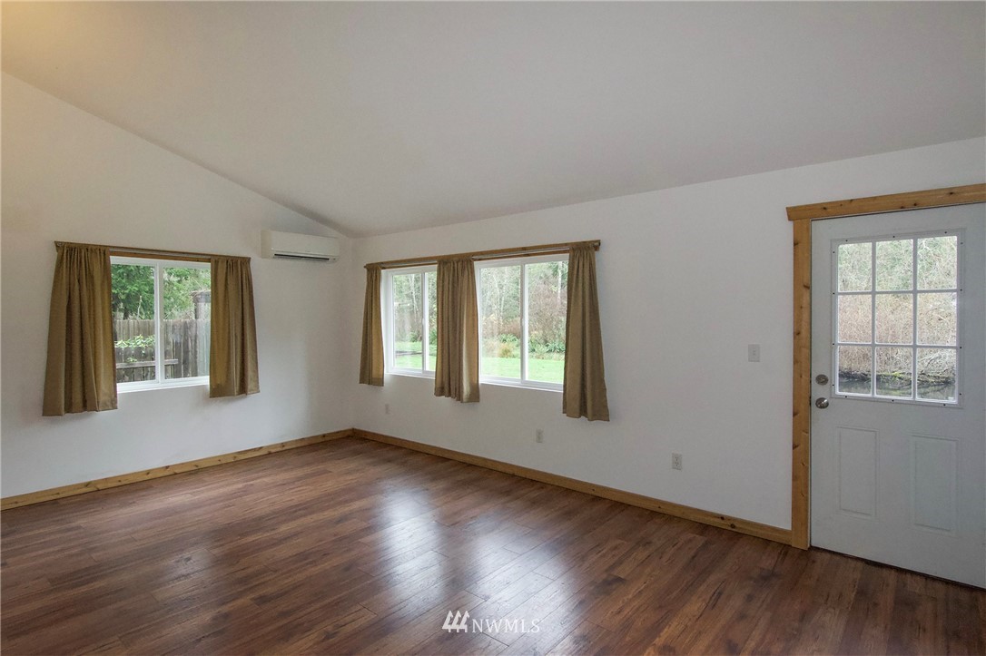 463 Autumn Road Sequim, WA 98382 - Photo 7 of 40 a view of an empty room with wooden floor and a window