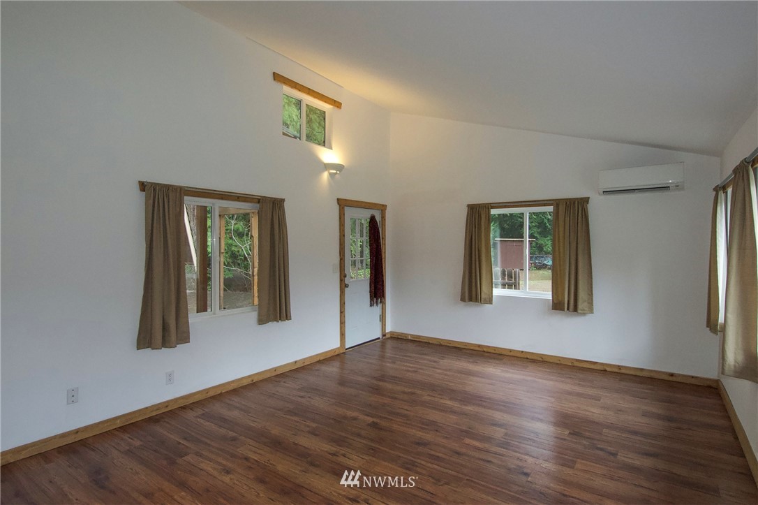 463 Autumn Road Sequim, WA 98382 - Photo 8 of 40 a view of an empty room with window and wooden floor