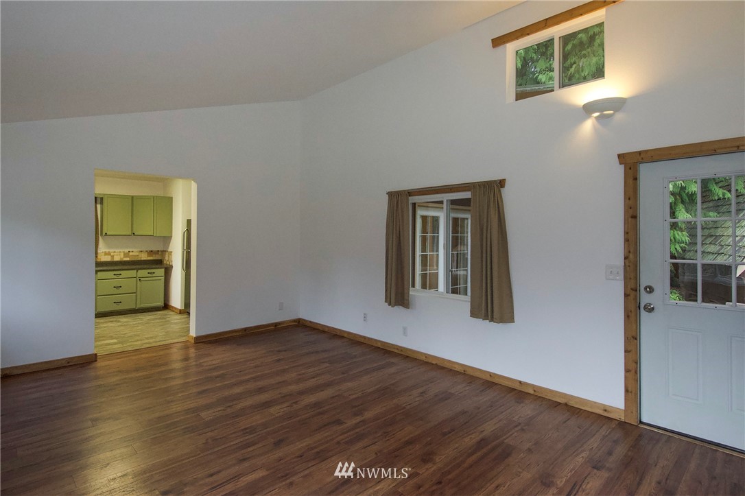 463 Autumn Road Sequim, WA 98382 - Photo 9 of 40 a view of an empty room with wooden floor and a window