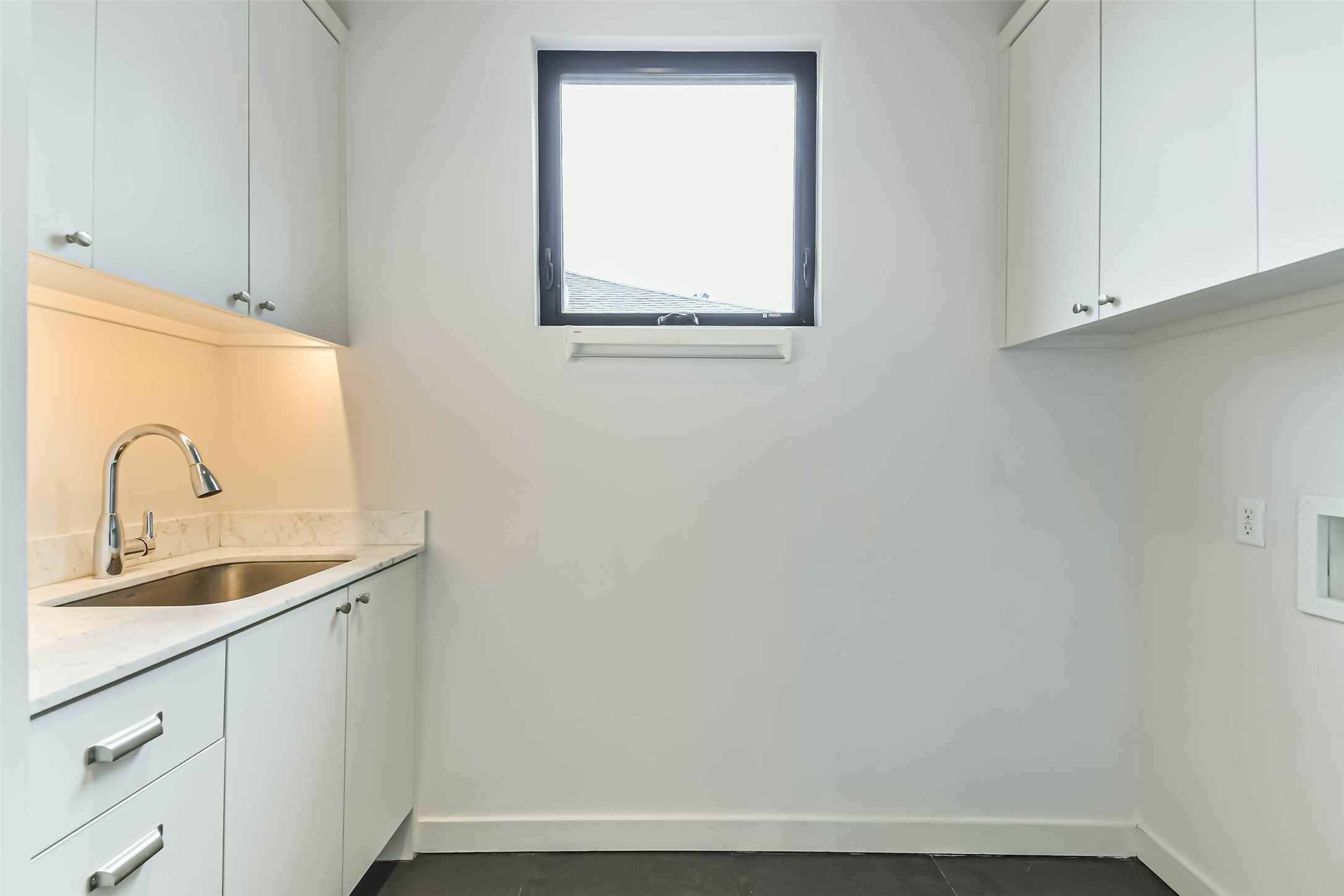 815 Alexander Street Houston, TX 77007 - Photo 26 of 49 Functional utility room with cabinetry, sink, and natural light.
