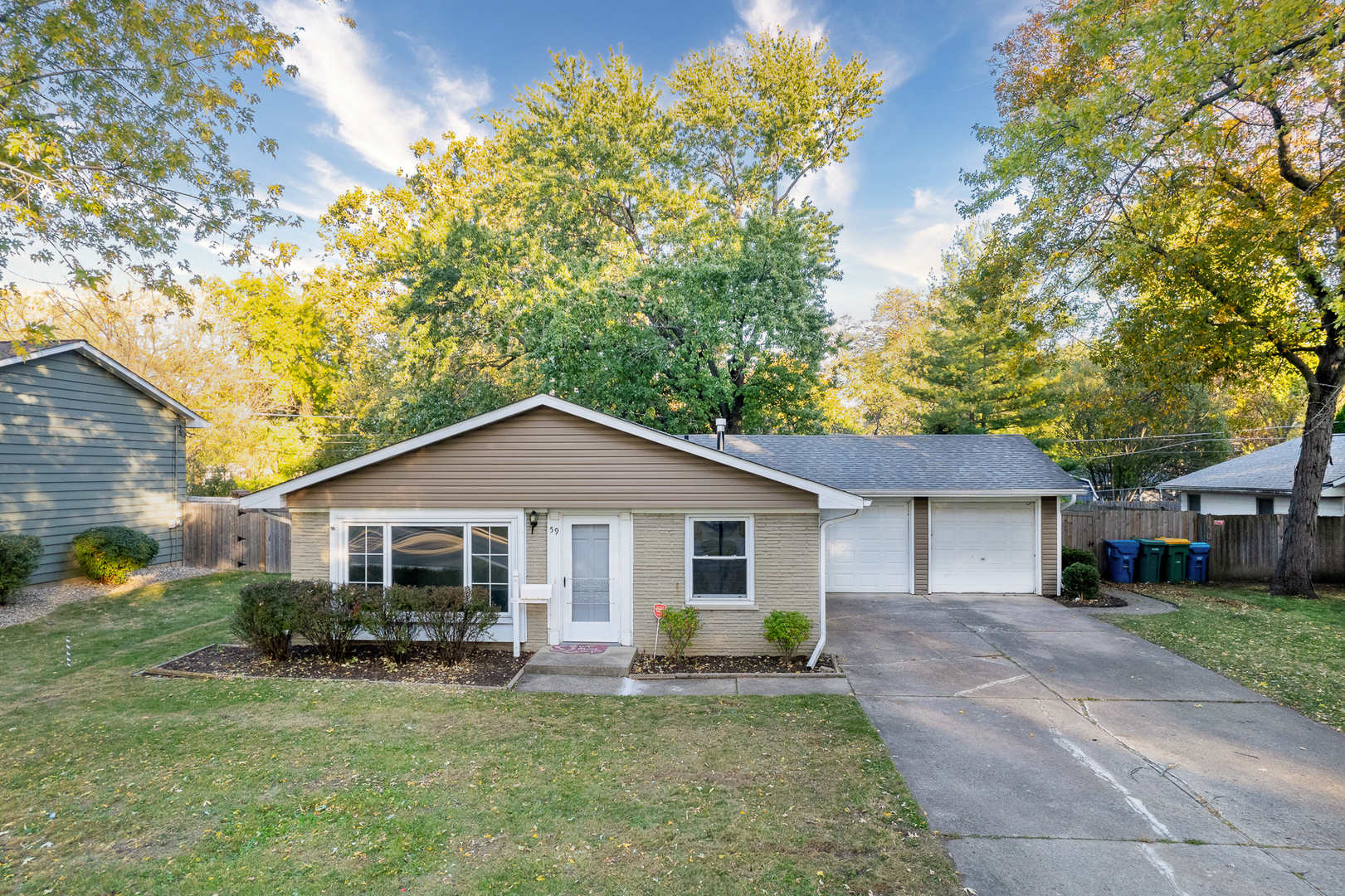 59 Briarcliff Road Montgomery, IL 60538 - Photo 3 of 34 a front view of a house with a garden and yard