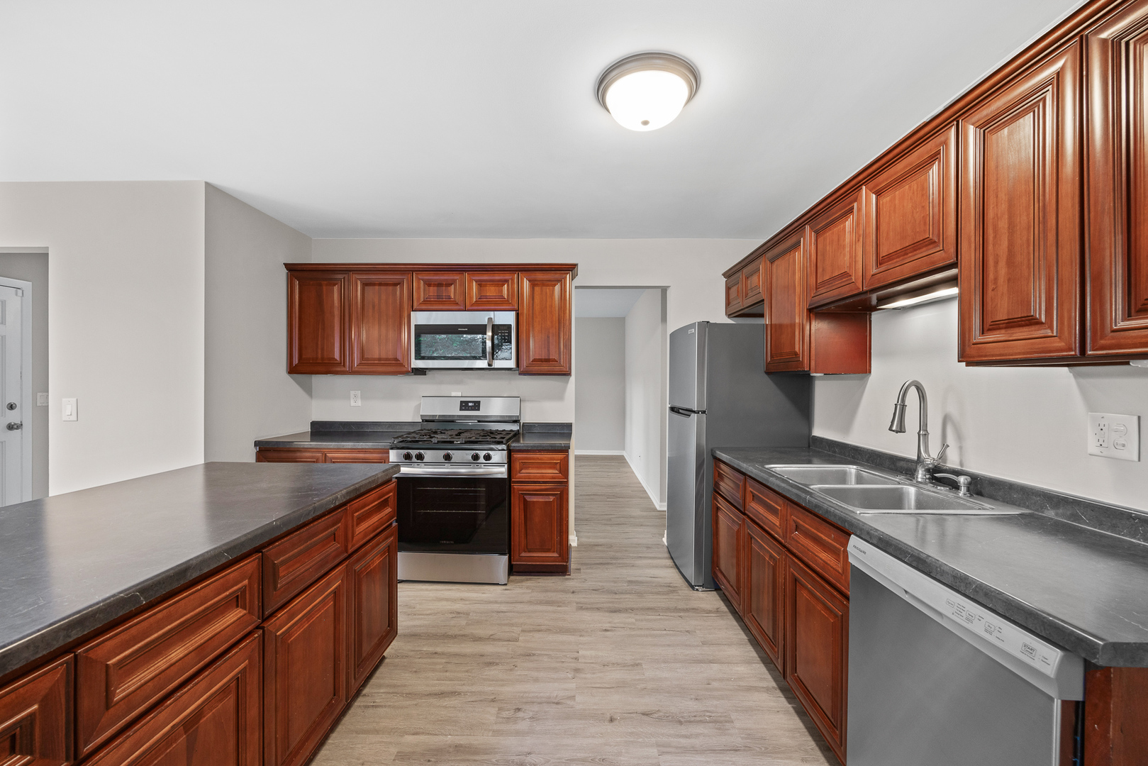 59 Briarcliff Road Montgomery, IL 60538 - Photo 7 of 34 a kitchen with stainless steel appliances granite countertop a sink stove and refrigerator