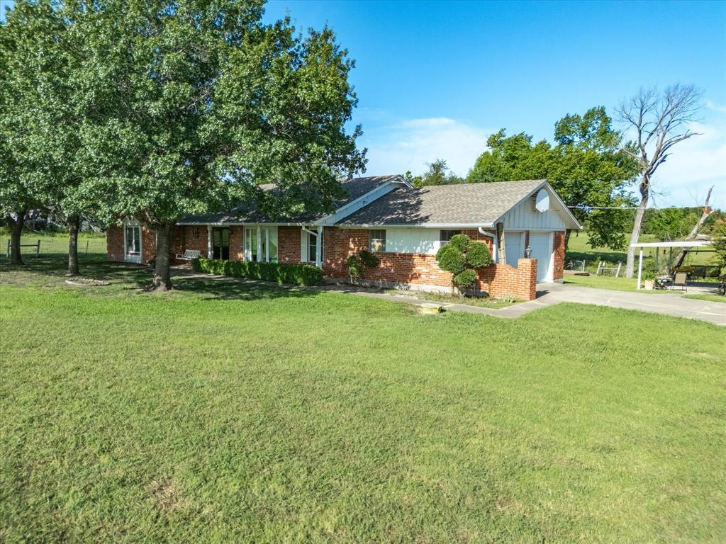2690 Kelly Road Aledo, TX 76008 - Photo 6 of 19 Single story home with brick siding, a garage, driveway, a front yard, and a shingled roof