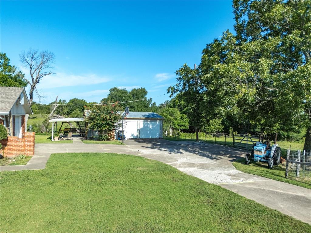 2690 Kelly Road Aledo, TX 76008 - Photo 9 of 19 View of yard featuring driveway and a garage