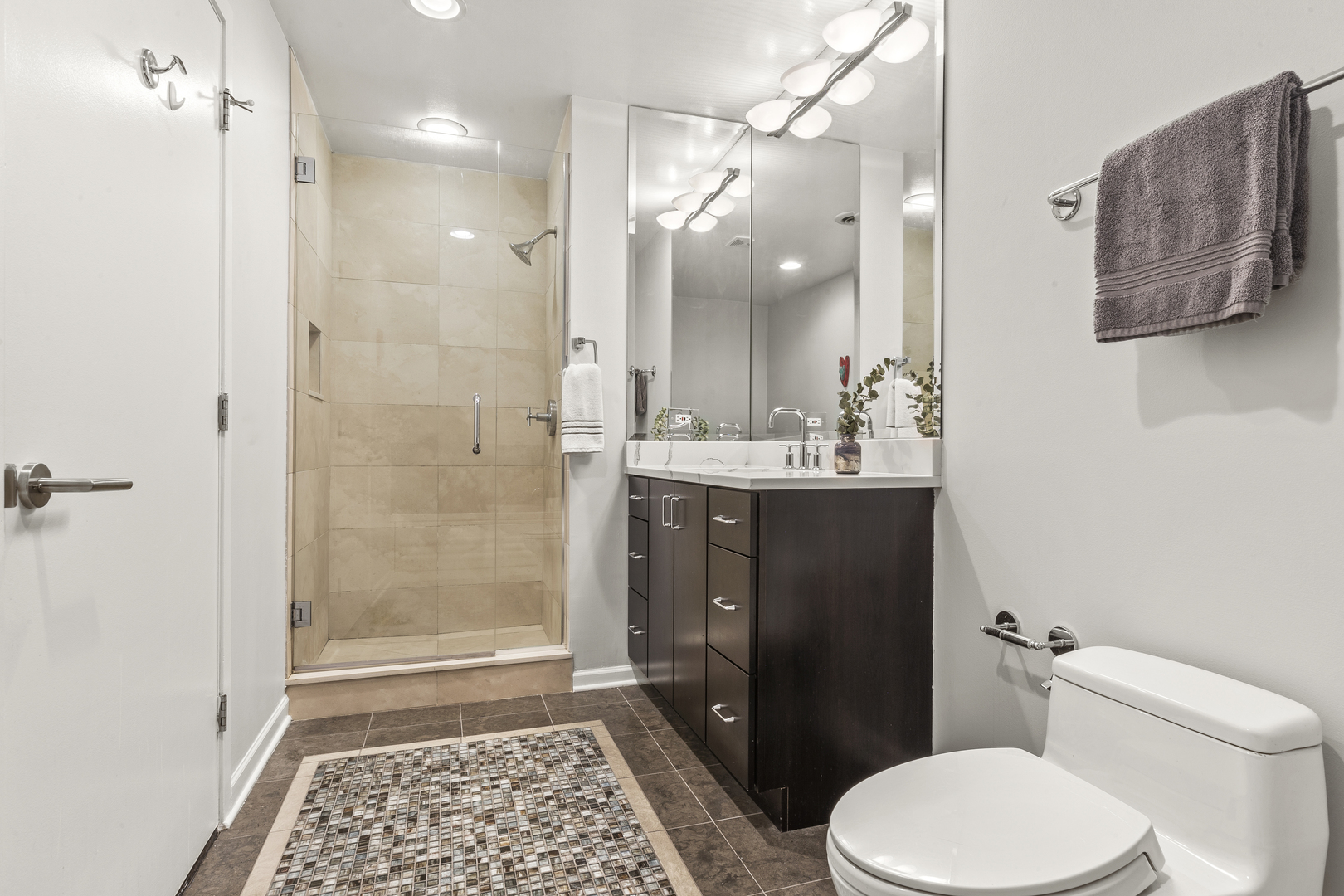 936 West Madison Street, Unit E4 Chicago, IL 60607 - Photo 16 of 21 a bathroom with a sink a toilet a shower and a mirror